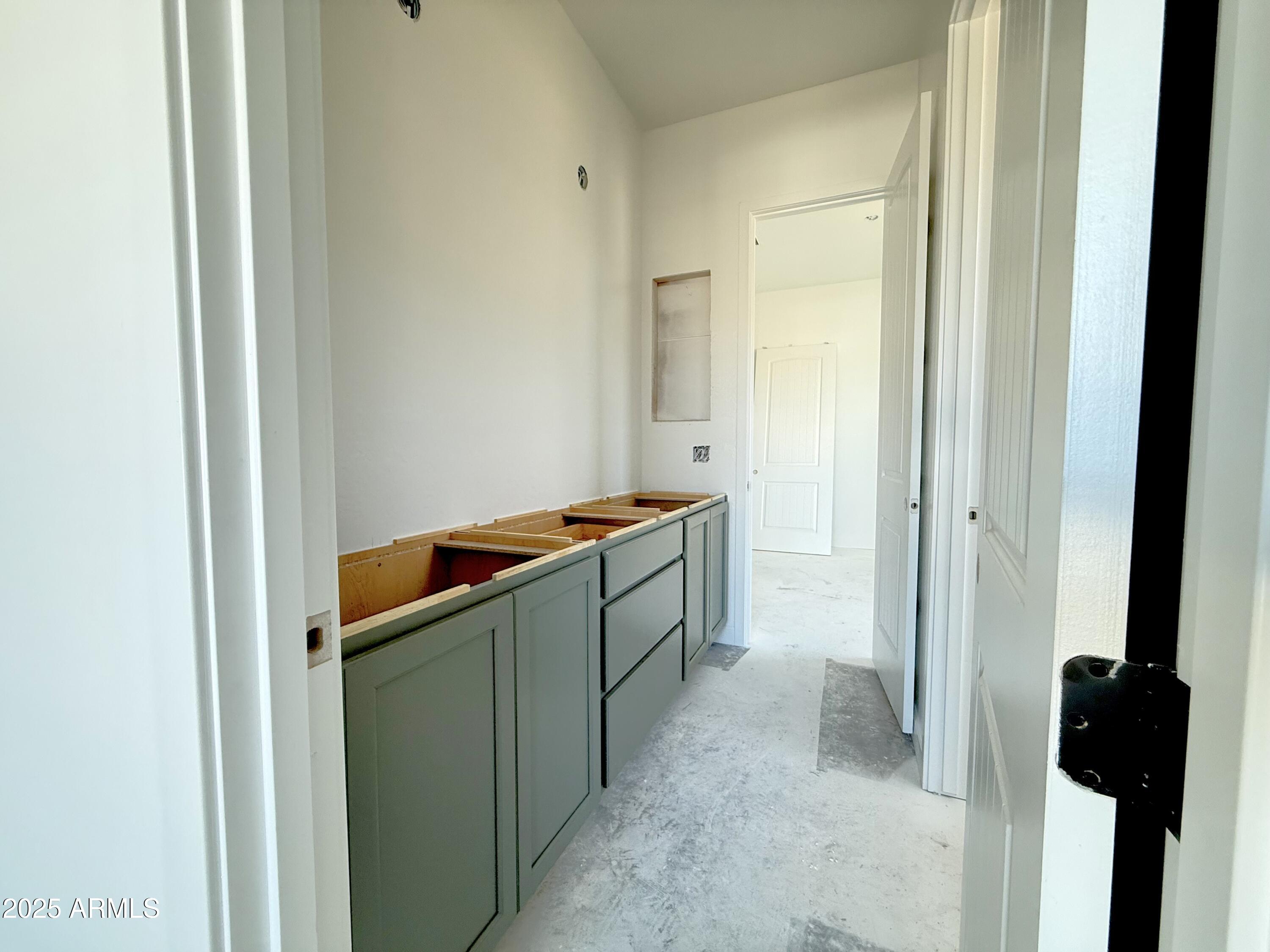22757 East Saddle Way Queen Creek, AZ 85142 - Photo 5 of 34 a kitchen with a refrigerator and a sink