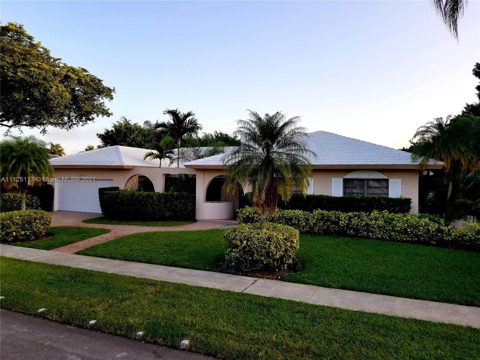 Emerald Hills Hollywood, FL 33021 - Photo 2 of 4 a front view of a house with a garden