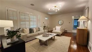 a living room with furniture a lamp and a large window