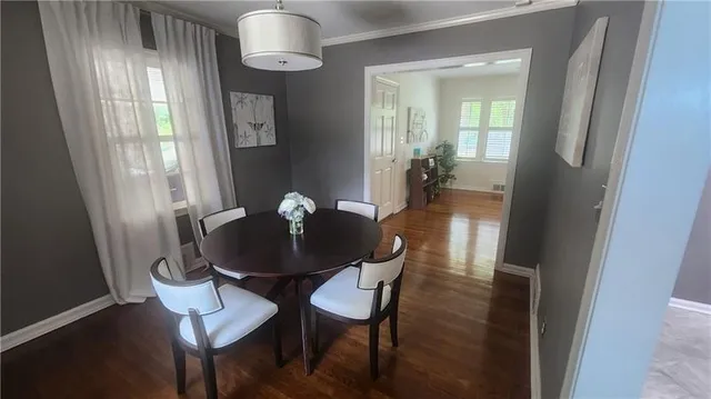 a view of a dining room with furniture and wooden floor