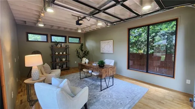 a living room with furniture and a floor to ceiling window
