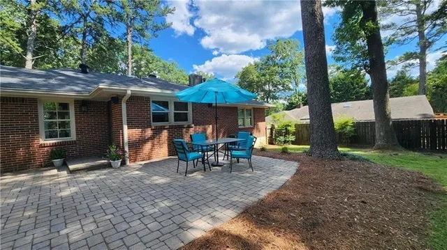 a view of a house with backyard sitting area and garden