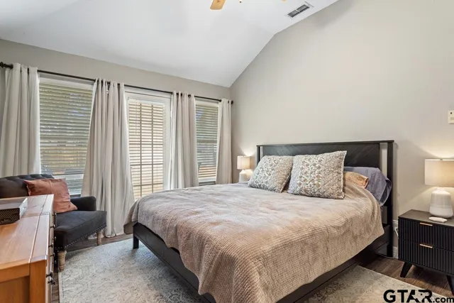 a large bed sitting in a bedroom next to a lamp