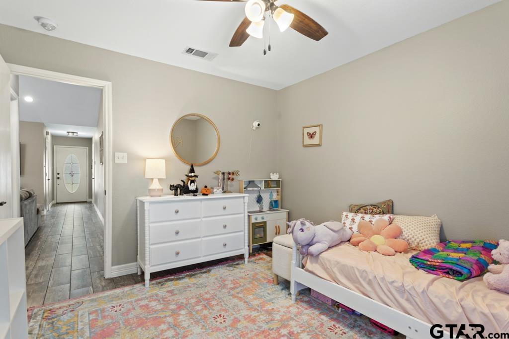 600 Frederick Circle Flint, TX 75762 - Photo 21 of 32 a bedroom with a bed and a chandelier