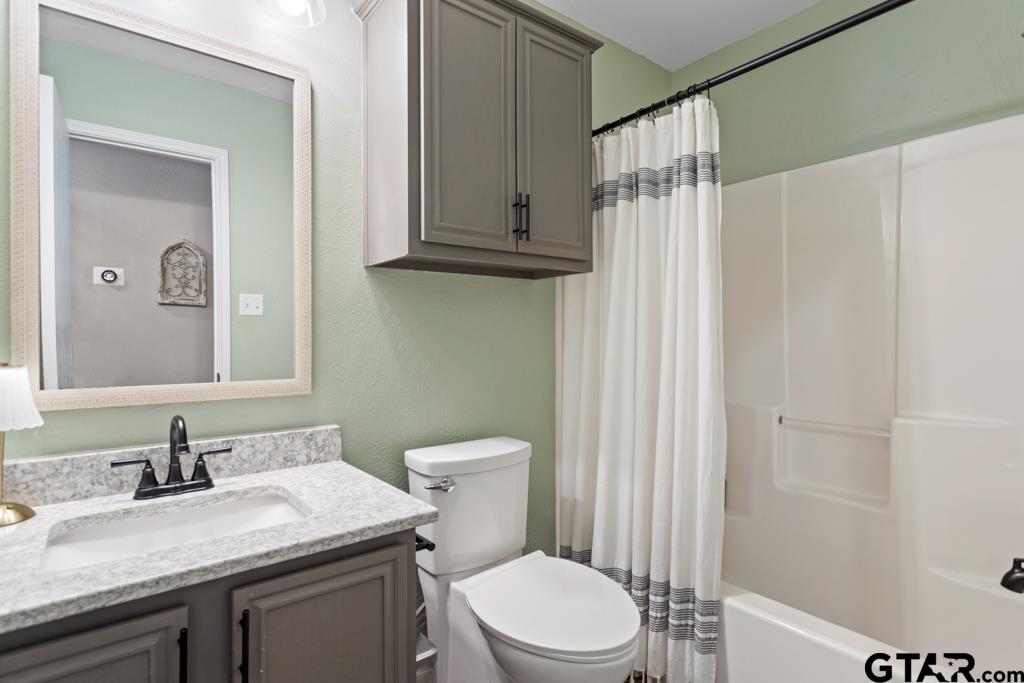 600 Frederick Circle Flint, TX 75762 - Photo 25 of 32 a bathroom with a granite countertop sink toilet and shower