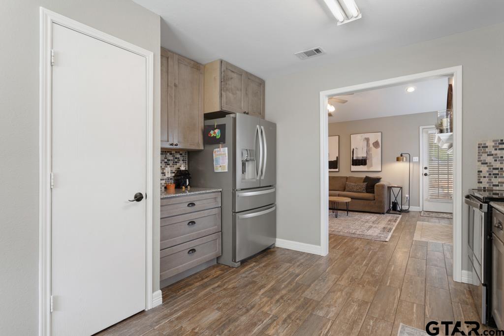 600 Frederick Circle Flint, TX 75762 - Photo 4 of 32 a view of a kitchen with a refrigerator a sink dishwasher and a wooden floor