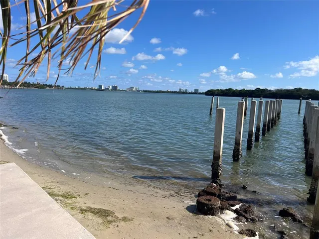 a kitchen with stainless steel appliances kitchen island lots of counter space and wooden floor