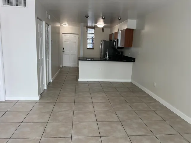 a kitchen with stainless steel appliances granite countertop a sink a microwave a stove and refrigerator