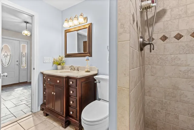 a bathroom with a sink vanity granite and toilet