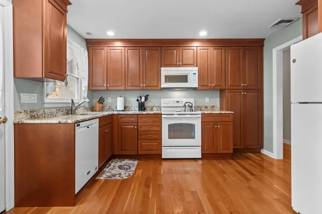 a kitchen with a sink cabinets stainless steel appliances and a window