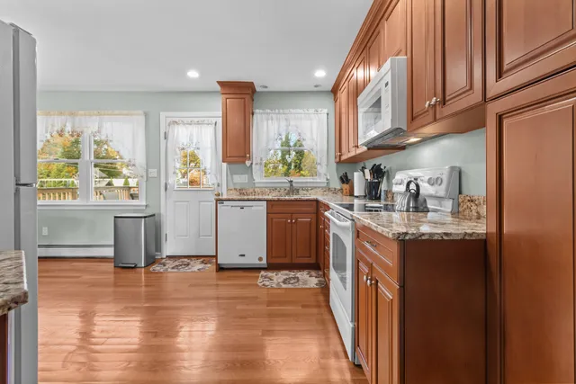 a kitchen with stainless steel appliances granite countertop a sink and a stove