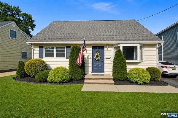 a view of a house with a yard and plants