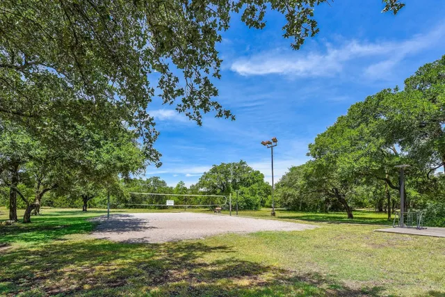 a view of a field with trees in the background