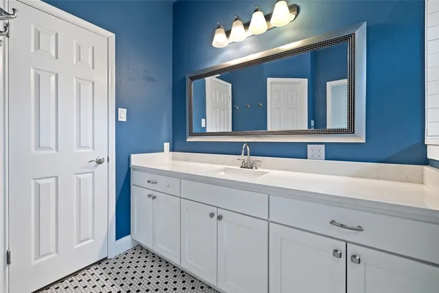 a bathroom with a sink and a mirror
