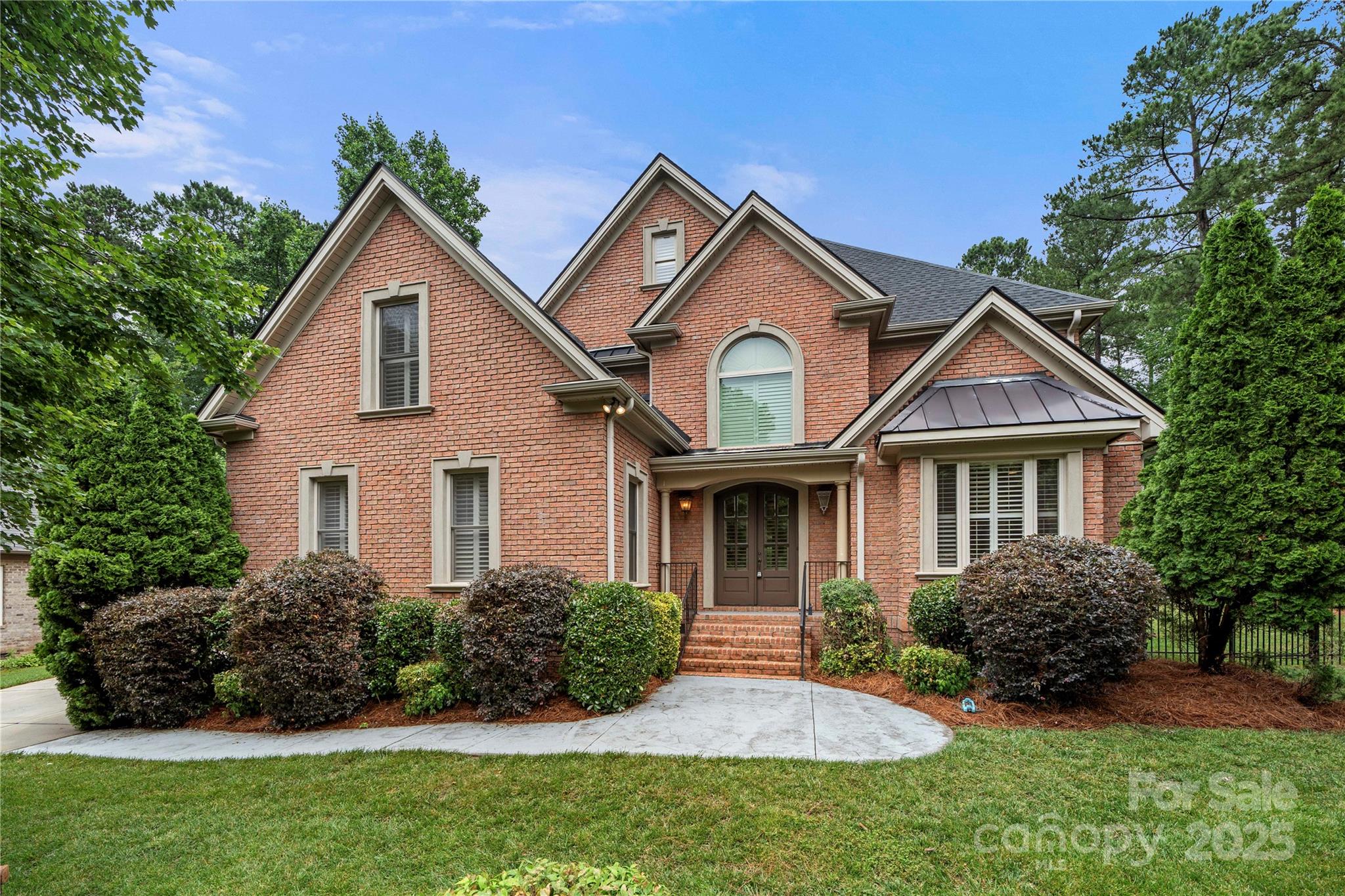a front view of a house with a garden
