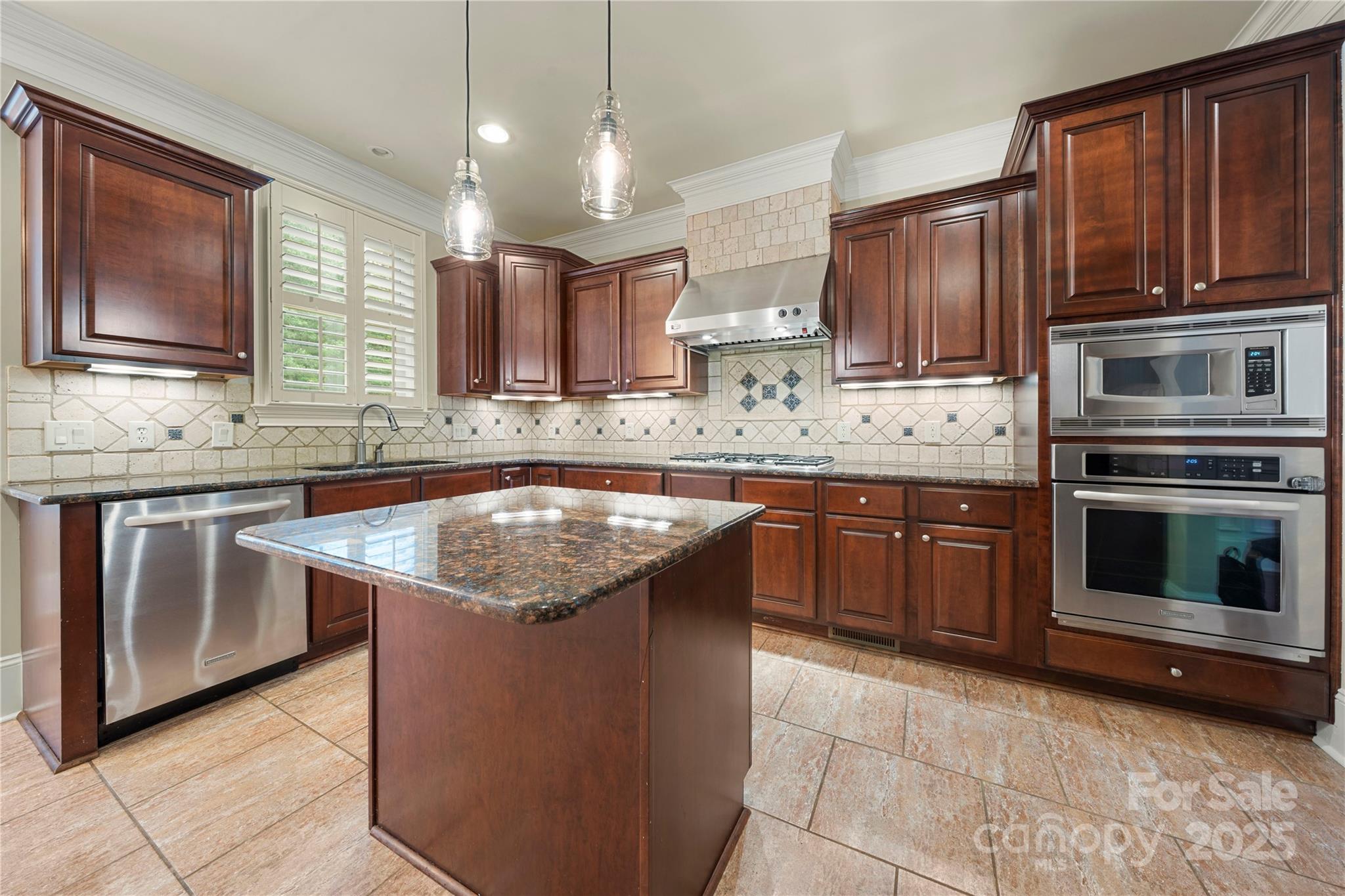 310 Ridge Reserve Drive Clover, SC 29710 - Photo 10 of 39 a kitchen with stainless steel appliances granite countertop a stove a sink and a microwave