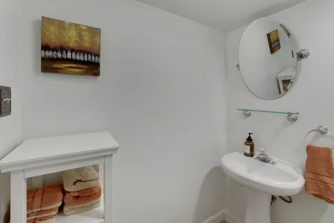 a bathroom with a sink a toilet and a mirror