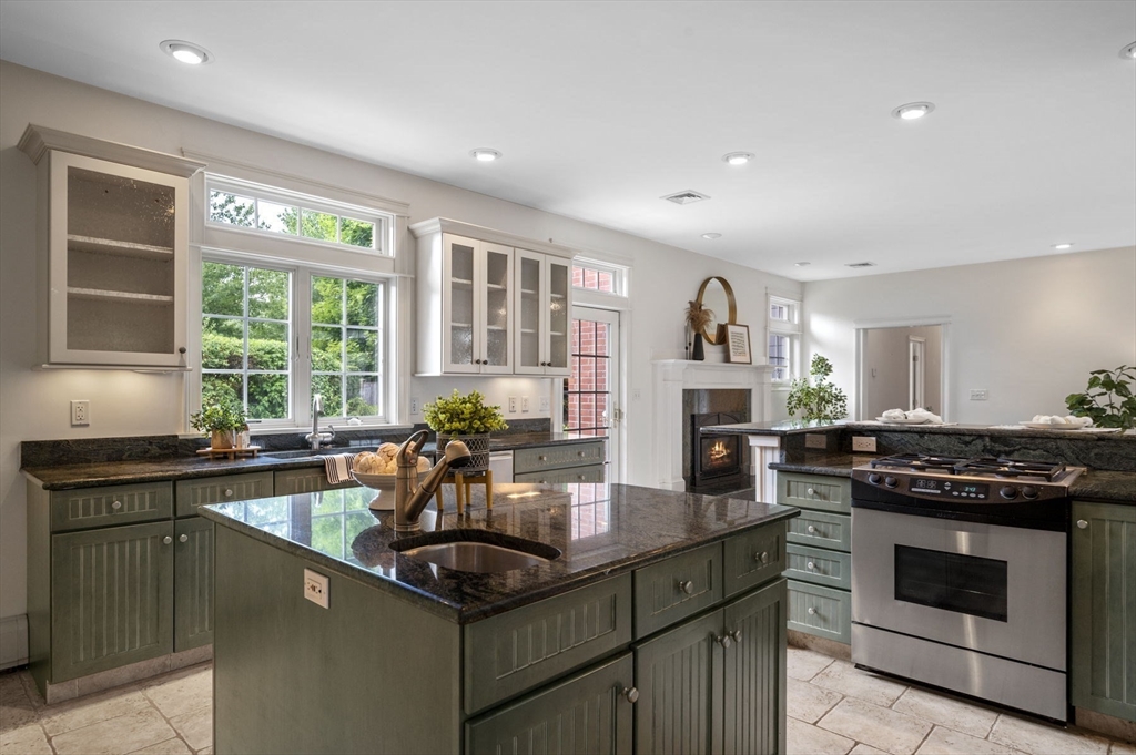 209 Maple Street Danvers, MA 01923 - Photo 19 of 42 a kitchen with stainless steel appliances granite countertop a stove a sink and a microwave