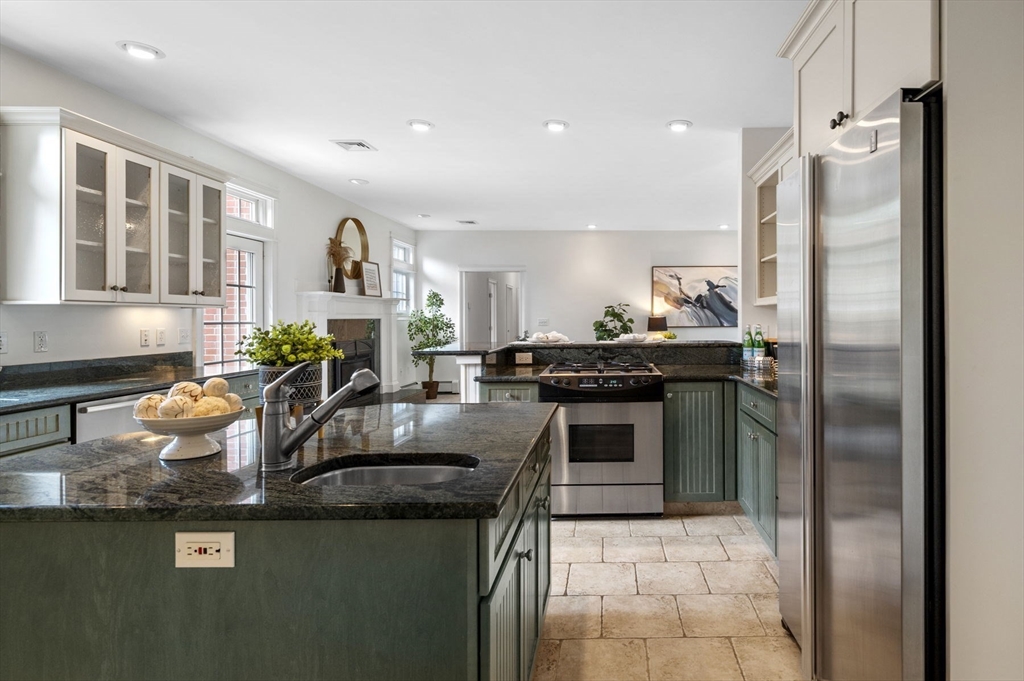 209 Maple Street Danvers, MA 01923 - Photo 20 of 42 a kitchen with stainless steel appliances granite countertop a sink stove and refrigerator