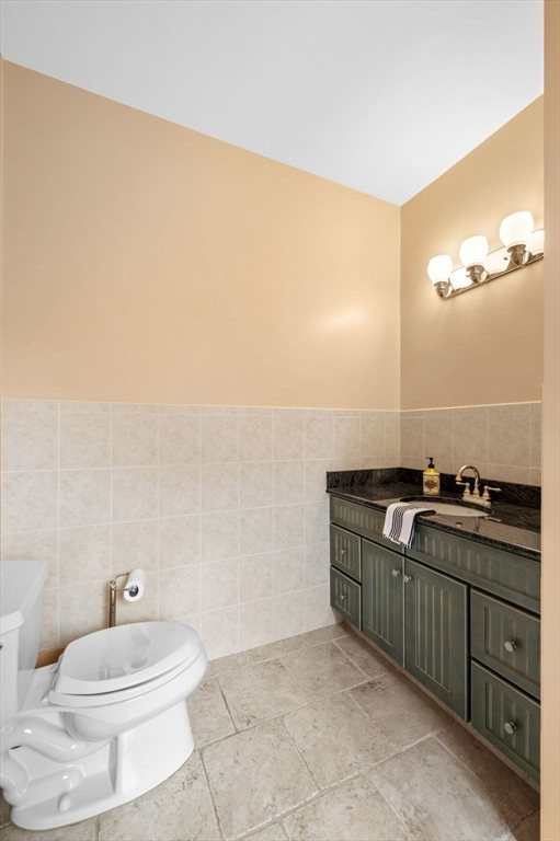 209 Maple Street Danvers, MA 01923 - Photo 22 of 42 a bathroom with a granite countertop sink and a mirror