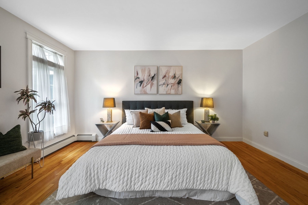 209 Maple Street Danvers, MA 01923 - Photo 25 of 42 a bedroom with a bed and wooden floor