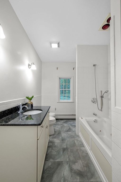 209 Maple Street Danvers, MA 01923 - Photo 27 of 42 a bathroom with a granite countertop sink a bathtub and a shower
