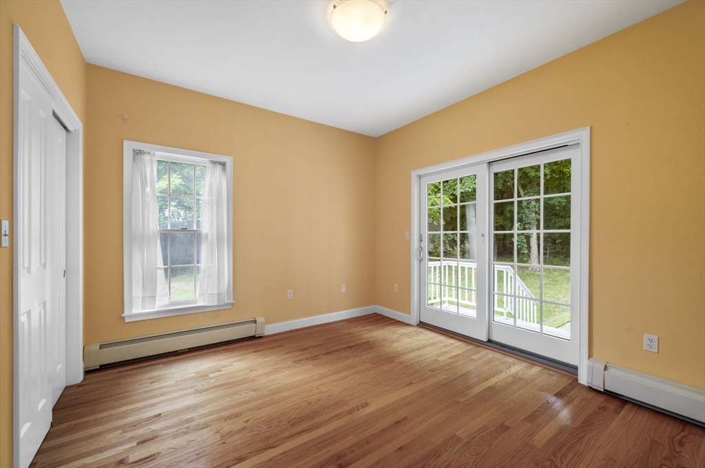 209 Maple Street Danvers, MA 01923 - Photo 30 of 42 a view of an empty room with wooden floor and a window