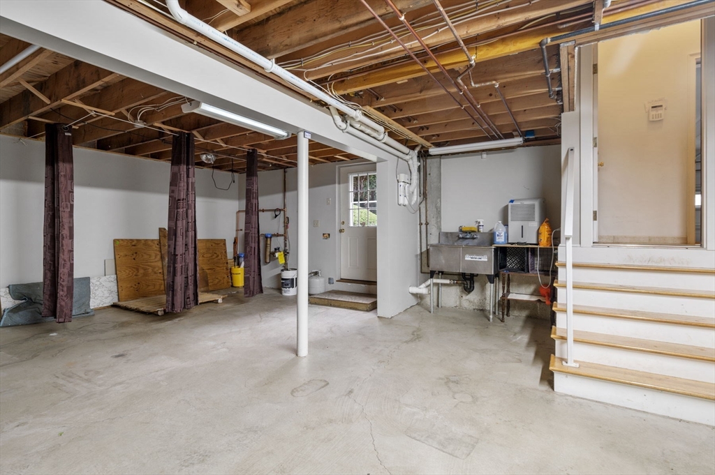 209 Maple Street Danvers, MA 01923 - Photo 35 of 42 a view of an empty room with wooden floor and furniture