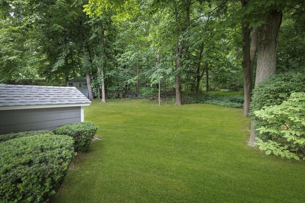 209 Maple Street Danvers, MA 01923 - Photo 40 of 42 a view of a backyard with a garden