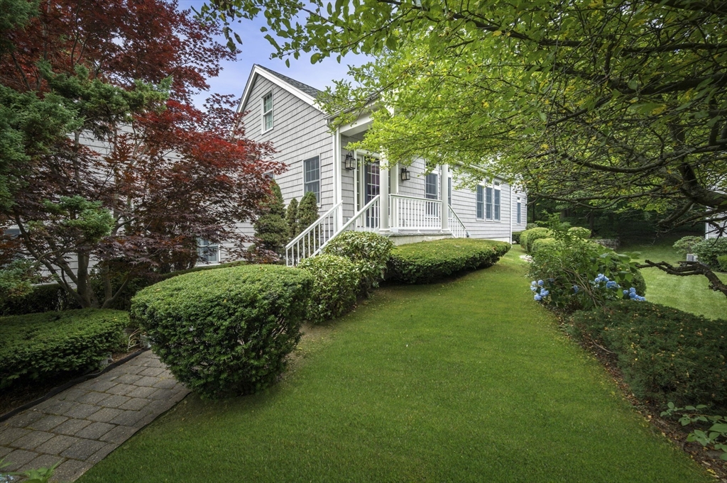 209 Maple Street Danvers, MA 01923 - Photo 5 of 42 a front view of a house with a garden