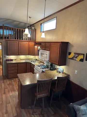 a kitchen with a table chairs and wooden floor