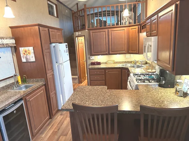 a kitchen with sink refrigerator and stove