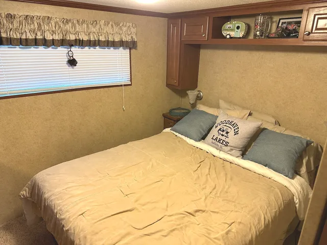 a bed sitting in a bedroom next to a bathroom