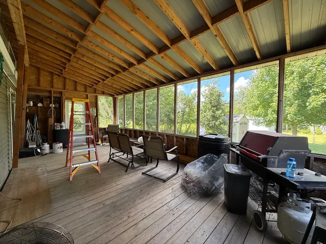 a living room with furniture and large windows