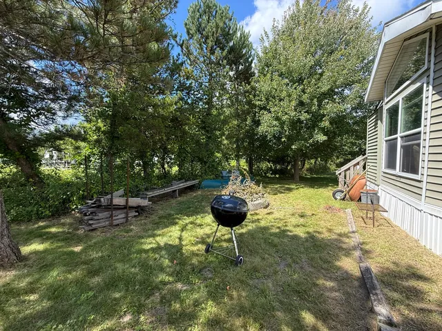a backyard of a house with table and chairs