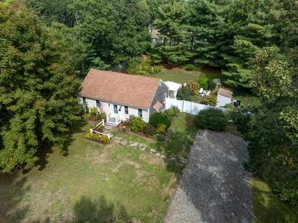an aerial view of a house with yard swimming pool and outdoor seating