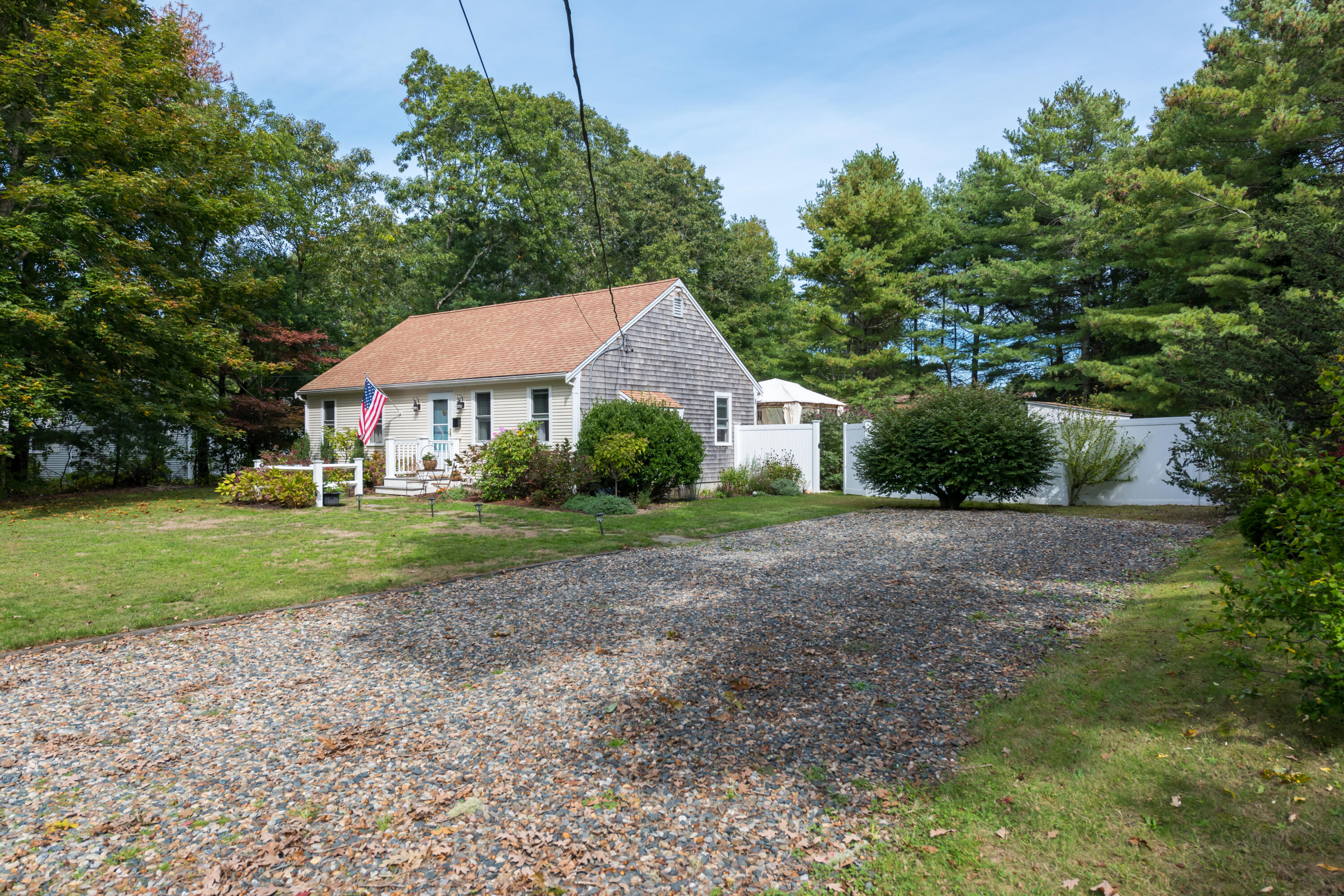 268 Bumps River Road Osterville, MA 02655 - Photo 2 of 33 a front view of a house with a yard