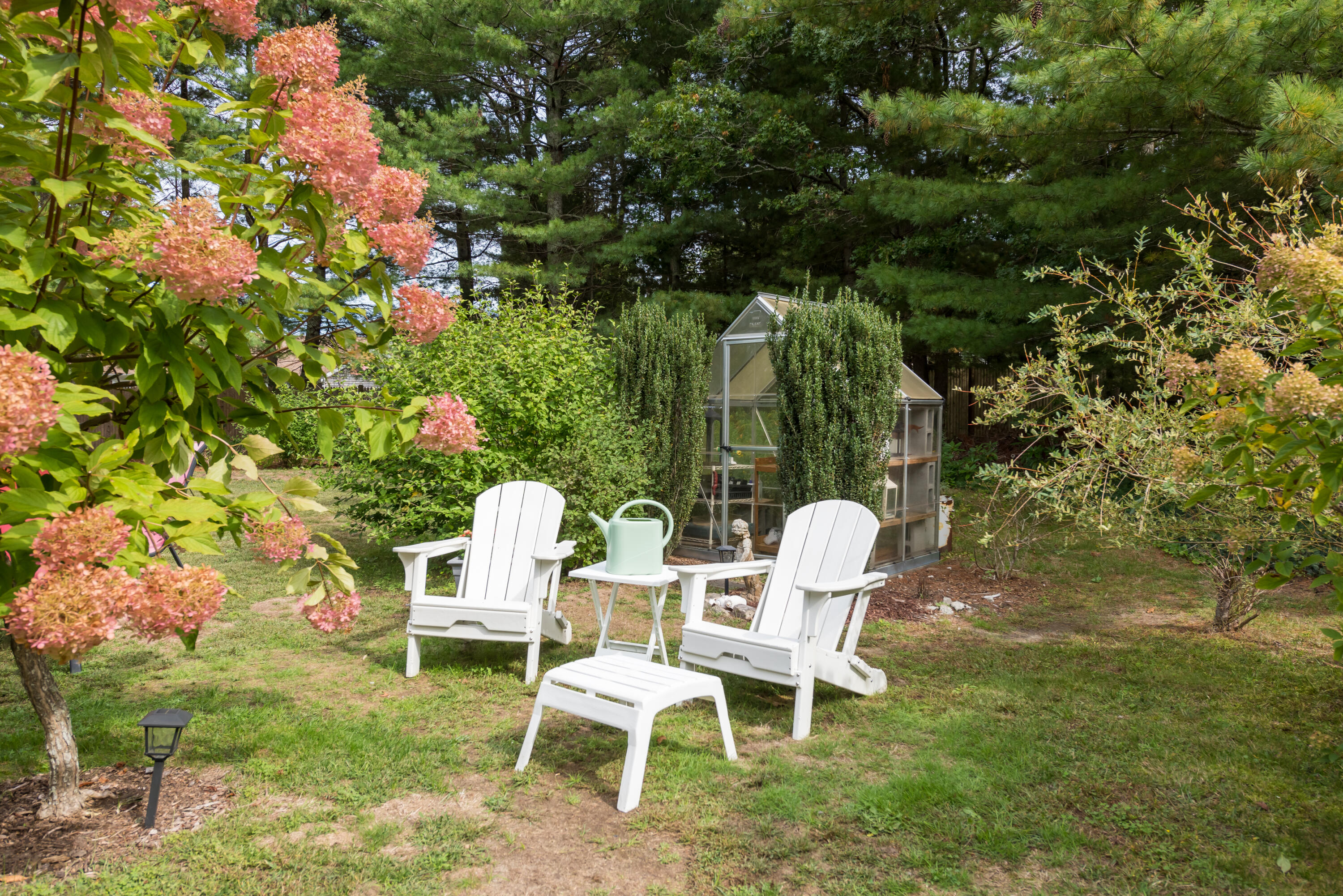 268 Bumps River Road Osterville, MA 02655 - Photo 21 of 33 a couple of chairs sitting in a backyard with large trees