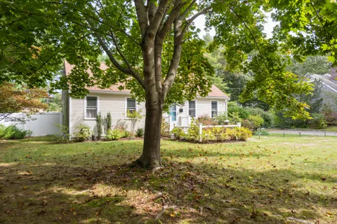 an aerial view of a house with a yard