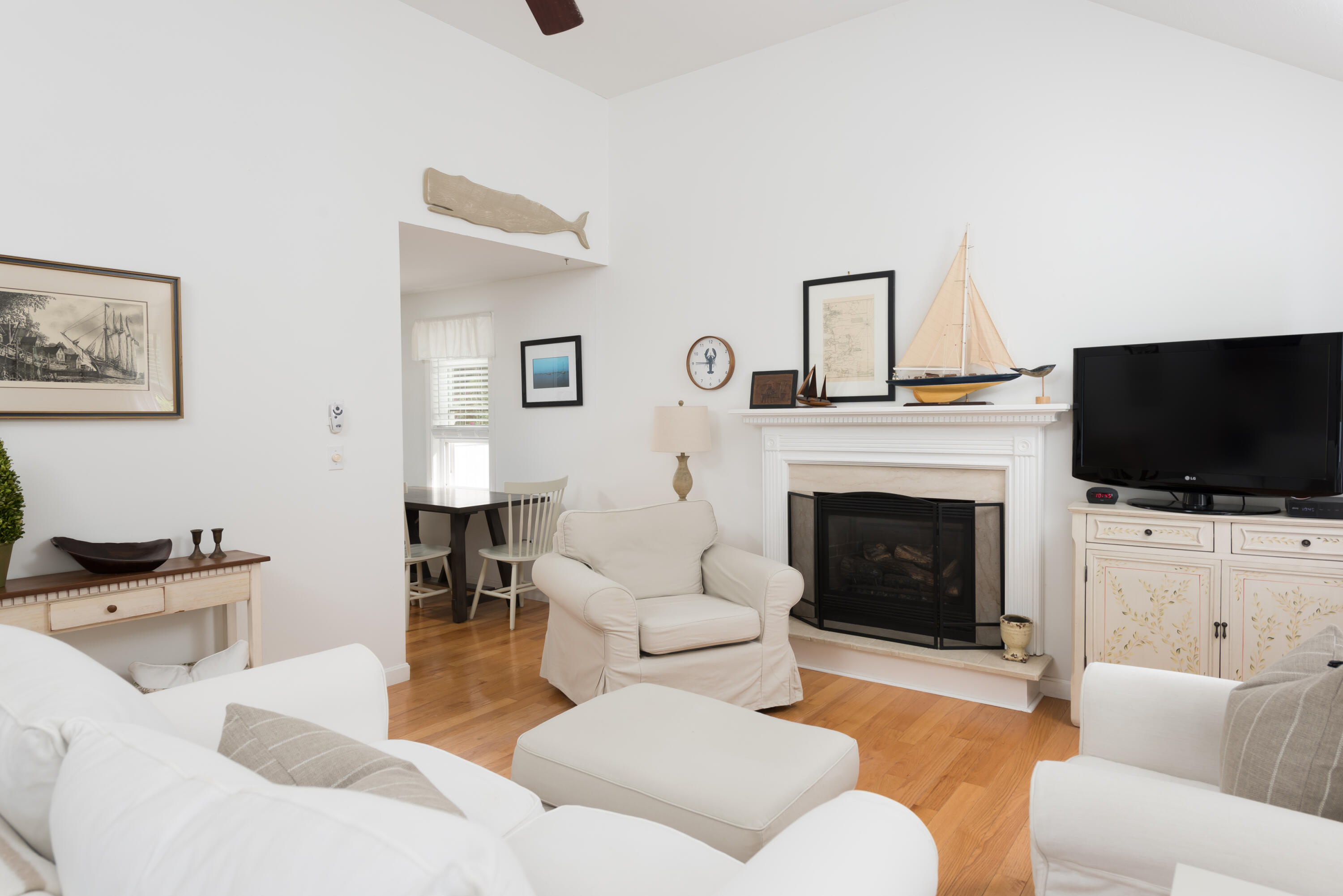 268 Bumps River Road Osterville, MA 02655 - Photo 4 of 33 a living room with furniture a flat screen tv and a fireplace