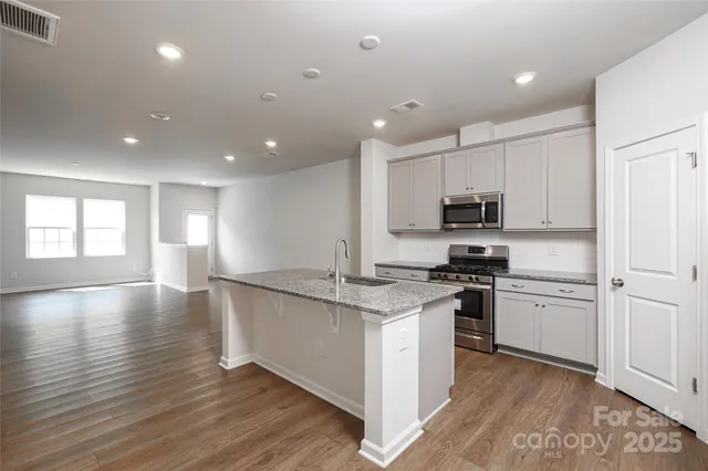 a kitchen with a refrigerator and a sink
