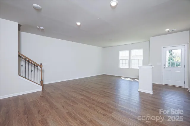 a view of kitchen and hall with wooden floor