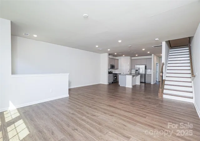 a view of kitchen with wooden floor and electronic appliances