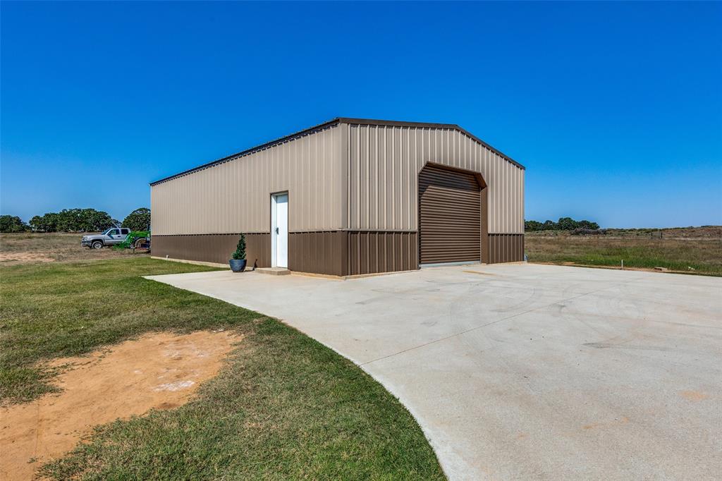 1150 Lone Star Road Bowie, TX 76230 - Photo 10 of 38 a view of a house with a yard