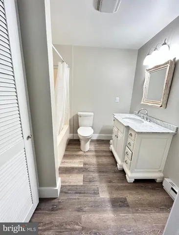 a spacious bathroom with a granite countertop sink and a mirror