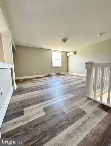a view of an empty room and wooden floor