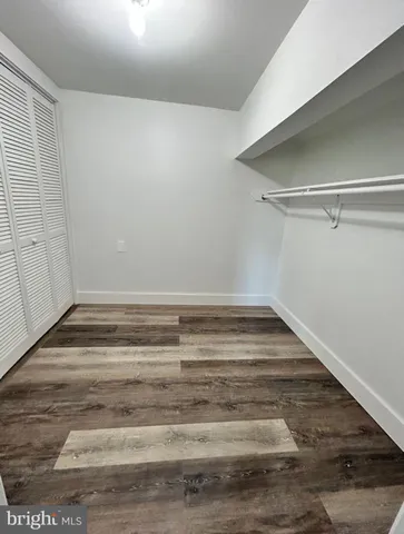 a view of a room with wooden floor
