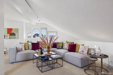 a view of a livingroom with furniture and staircase