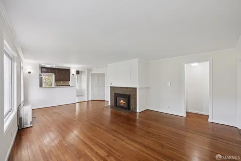 a view of a balcony with wooden floor and fence