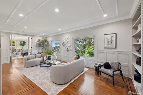 a living room with furniture fireplace and a flat screen tv